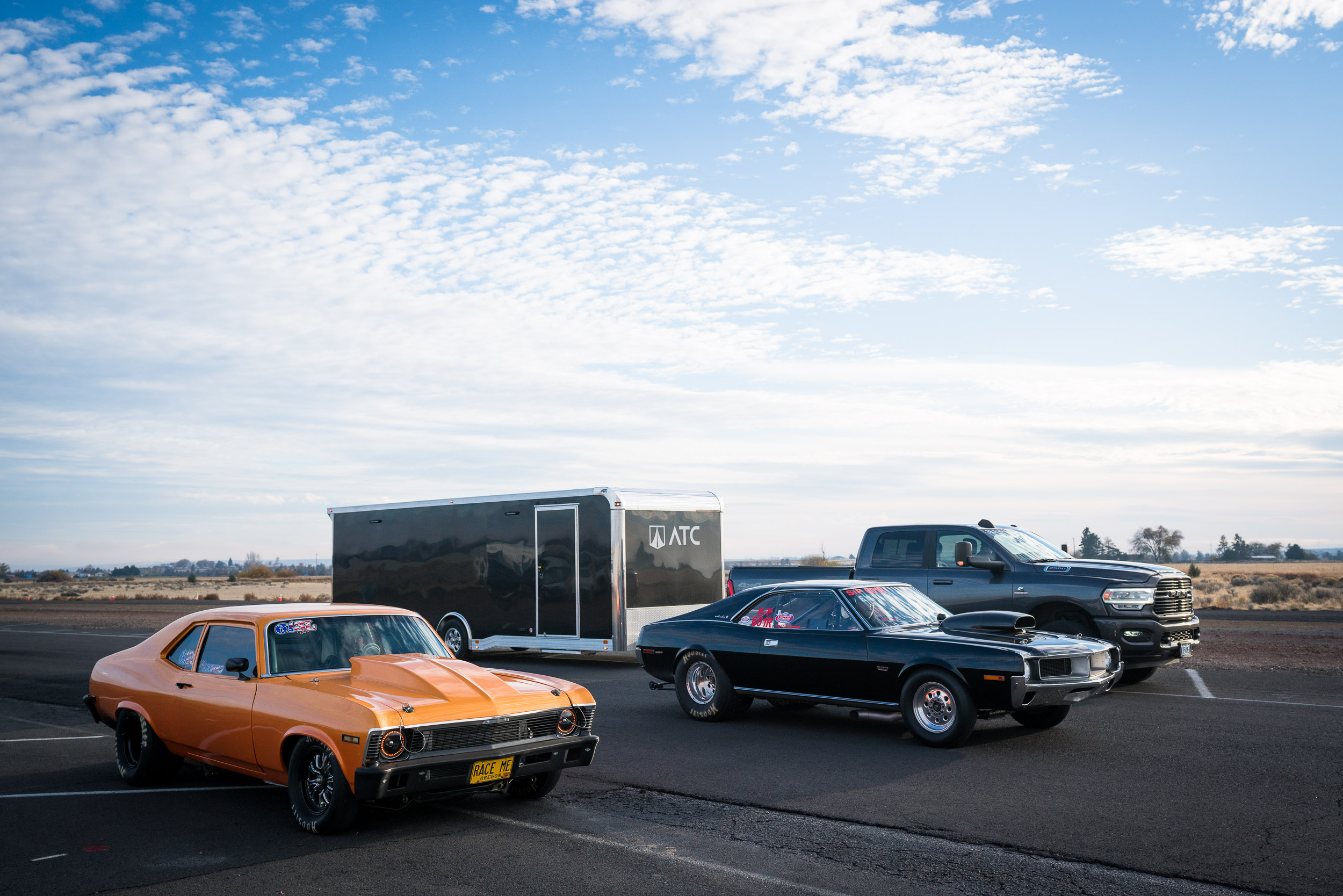 Photo of racecars in front of an ATC car hauler.